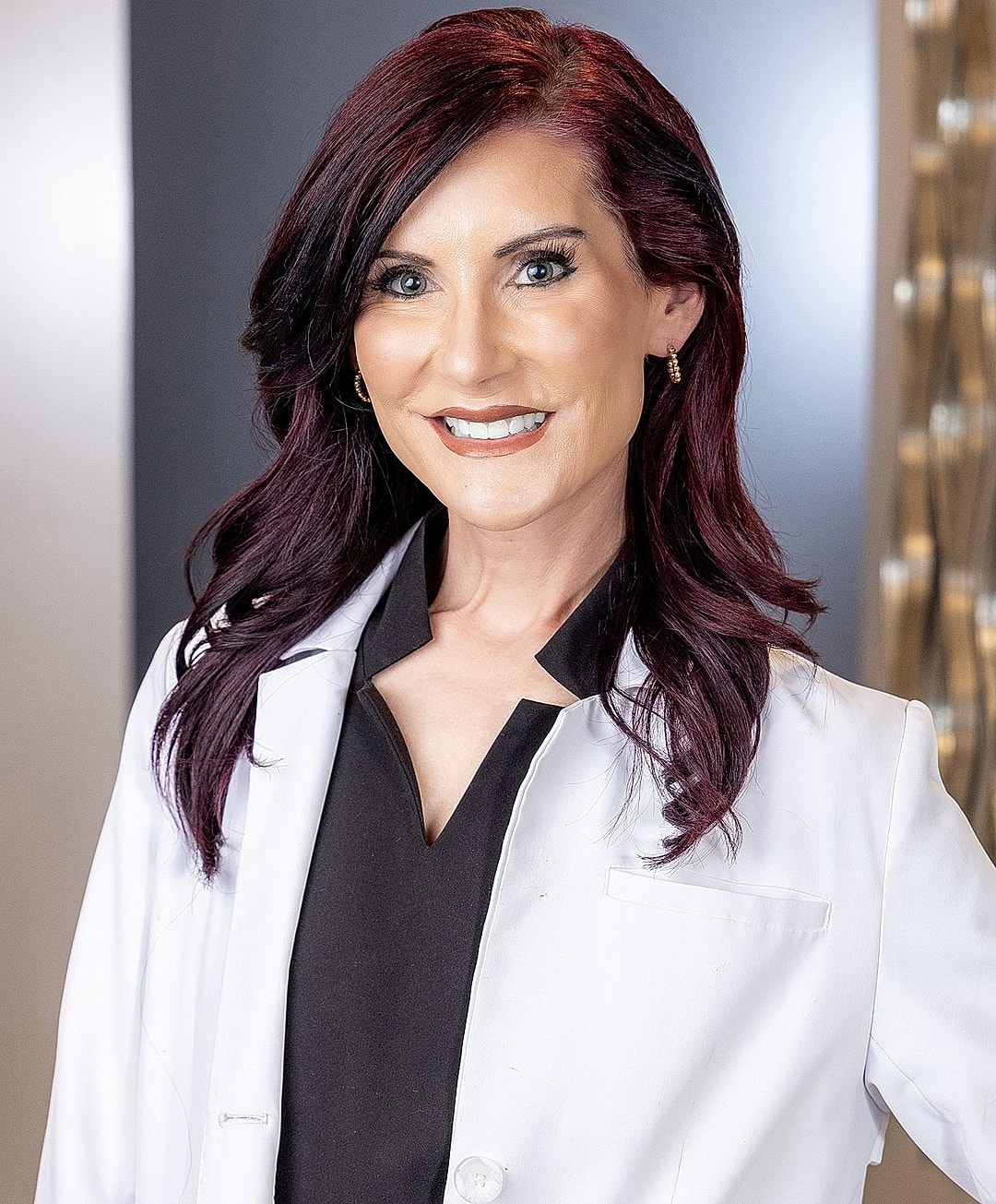 Manor Medpa Medical Director Dr. Leslie Predmore in white coat smiling