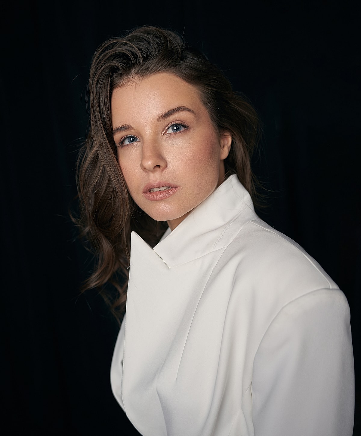 Portrait of a woman in a white blazer.