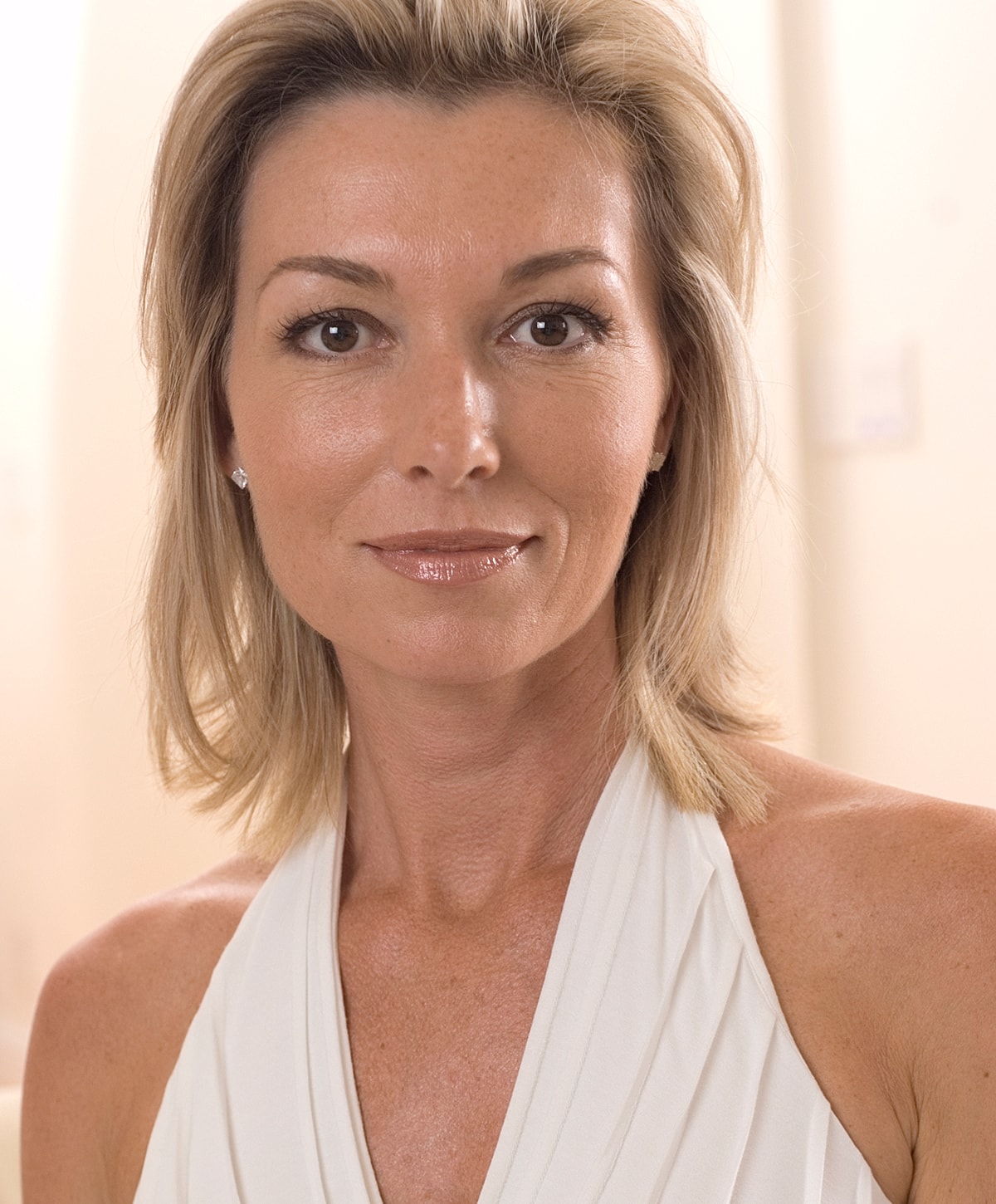 Woman with blonde hair in a white dress.