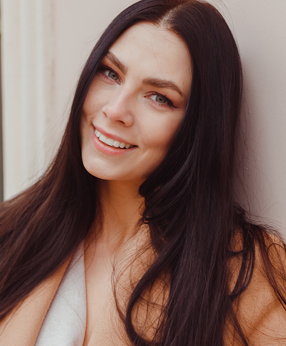 Smiling woman with long dark hair.