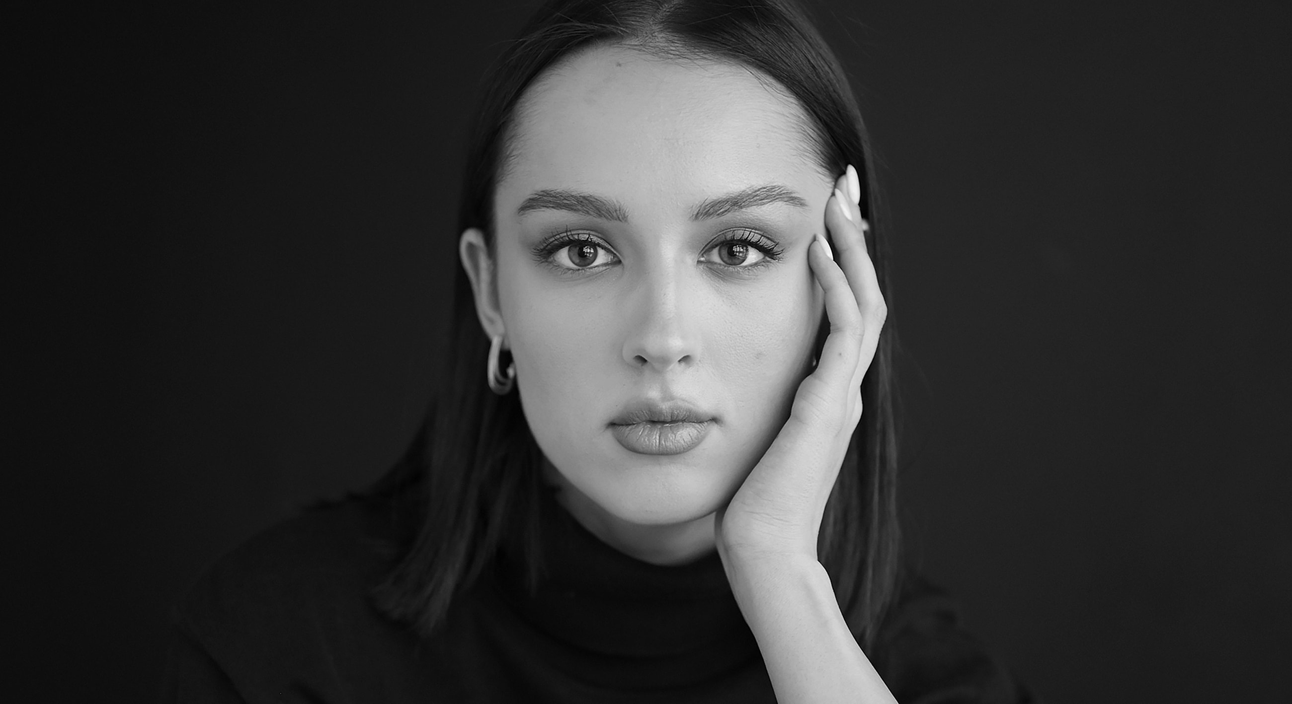 Black and white portrait of thoughtful young woman.